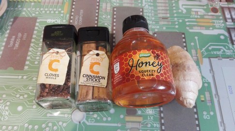 ingredients for elderberry syrup cloves cinnamon sticks honey root ginger