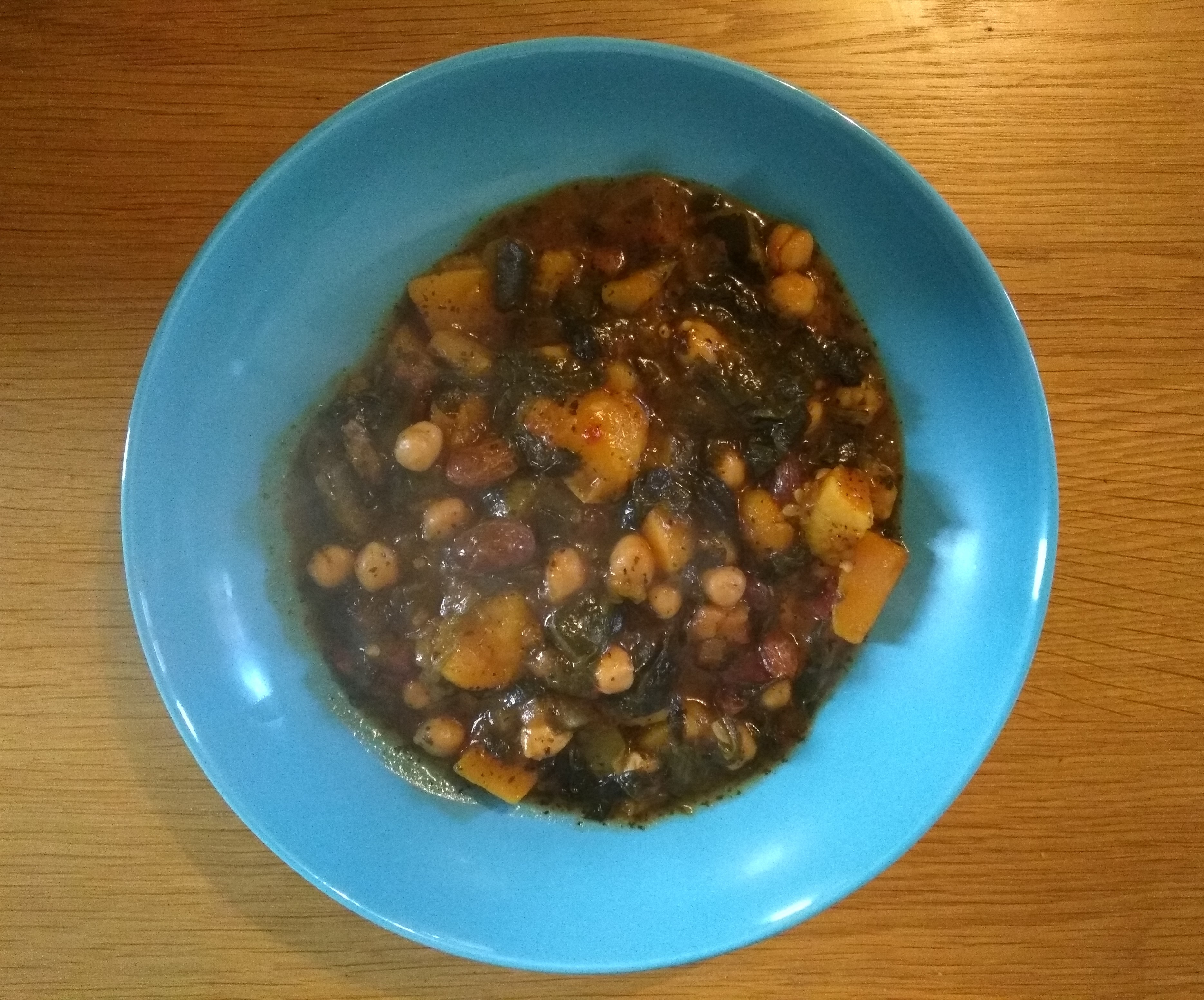 easy vegan Moroccan tagine in a blue bowl on a wooden table