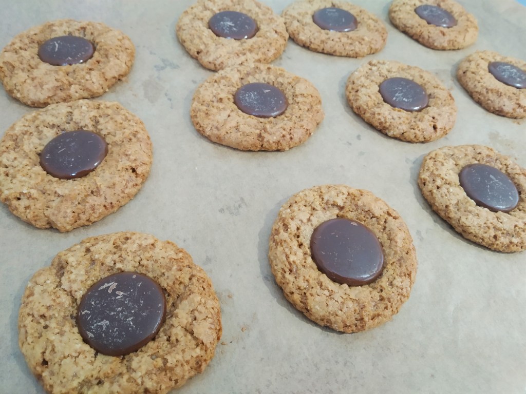 spooky spider halloween biscuits chocolate buttons on biscuits on a baking tray. easy recipe.