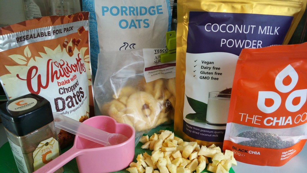 quick and easy gluten free porridge recipe, vegan, plant based breakfast, oatmeal. Ingredients on the counter here - whitworths chopped dates, ground cinnamon, dried chopped apple, coconut milk powder, chia seeds and oats