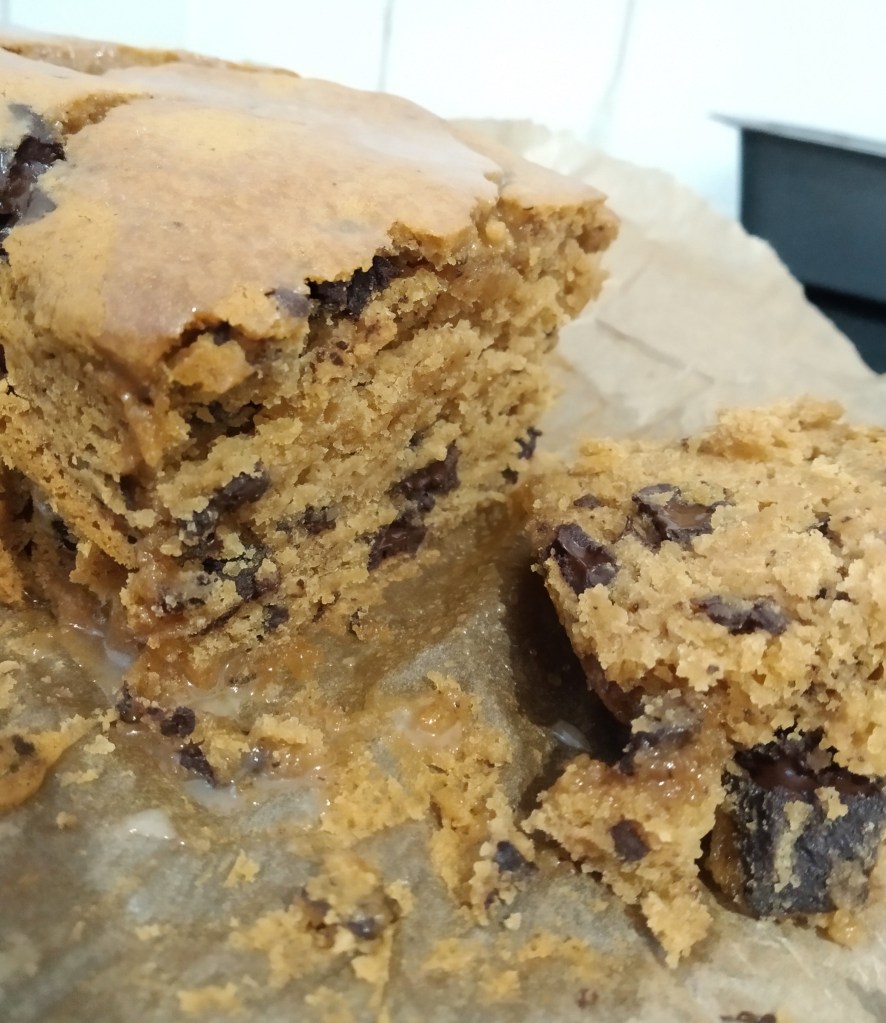 gluten free vegan lebkuchen loaf close up fresh out of the oven on baking paper. Refined sugar free with chocolate chips