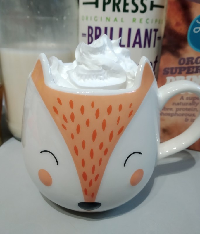 pink hot chocolate in a fox mug with dairy free whipped cream on top sugar free