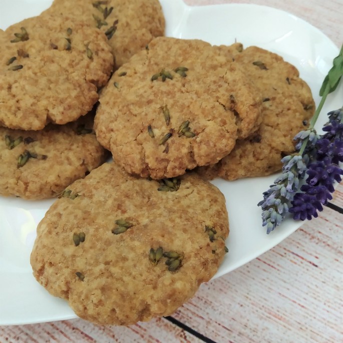 gluten free and vegan lavender and ginger biscuits on a white plate with sprigs of fresh lavender