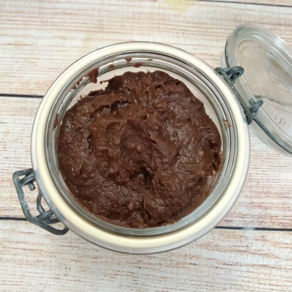 rich vegan chocolate chestnut spread in a glass jar on a table